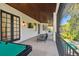 Spacious covered patio featuring a lounge area, television and a pool table at 4313 W Beachway Dr, Tampa, FL 33609