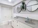 Bathroom features double sinks, framed mirrors, and a shower-tub combo with white tile at 4405 Vieux Carre Cir # 4405, Tampa, FL 33613