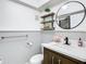 Cozy bathroom featuring decorative shelves and a round mirror at 4405 Vieux Carre Cir # 4405, Tampa, FL 33613