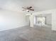 Bright bedroom features carpet floors, ceiling fan, a door leading outside, and a closet with mirrored doors at 4405 Vieux Carre Cir # 4405, Tampa, FL 33613