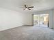 Bright bedroom features carpet floors, ceiling fan, and a door leading to a balcony at 4405 Vieux Carre Cir # 4405, Tampa, FL 33613