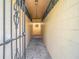 Long entrance walkway to front door, secured by iron gate at 4405 Vieux Carre Cir # 4405, Tampa, FL 33613