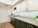 Updated kitchen with pantry, sleek granite countertops, modern appliances, and stylish black cabinetry at 4405 Vieux Carre Cir # 4405, Tampa, FL 33613