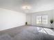 Bright living room with gray carpet, fresh white walls, and contemporary chandelier at 4405 Vieux Carre Cir # 4405, Tampa, FL 33613