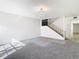 Spacious living room with gray carpet, white walls, and a staircase at 4405 Vieux Carre Cir # 4405, Tampa, FL 33613