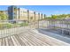 Large patio with wrought iron railings, offering a lovely view of a building, trees, and street at 4405 Vieux Carre Cir # 4405, Tampa, FL 33613