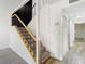 Carpeted staircase with wooden railing, and modern wall decor at 4405 Vieux Carre Cir # 4405, Tampa, FL 33613
