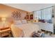 Cozy bedroom with natural light from the window, complemented by unique decor and furnishings at 4705 1St Ne St # 326, St Petersburg, FL 33703