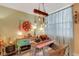Charming dining space featuring unique decor, a pink table, and rustic chandelier for a cozy atmosphere at 4705 1St Ne St # 326, St Petersburg, FL 33703
