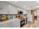 Modern kitchen featuring stainless steel appliances, white cabinets, gray marble backsplash and wood floor at 4705 1St Ne St # 326, St Petersburg, FL 33703