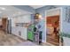 Bright kitchen features white cabinets, stylish decor, a built-in wine fridge and convenient access to the adjacent bedroom at 4705 1St Ne St # 326, St Petersburg, FL 33703