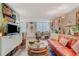 Bright eclectic living room featuring unique art, bright sofa, and decorative lighting at 4705 1St Ne St # 326, St Petersburg, FL 33703