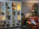 Stylish living room featuring a large bookshelf, decorative items, and a cozy couch for relaxation and comfort at 4705 1St Ne St # 326, St Petersburg, FL 33703