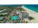 Aerial view of condo building along ocean with sandy beach at 4950 Gulf Blvd # 409, St Pete Beach, Fl, FL 33706