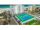 Aerial view of condo building with tennis courts and parking at 4950 Gulf Blvd # 409, St Pete Beach, Fl, FL 33706