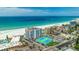 A distant aerial view shows community tennis courts and the ocean front location at 4950 Gulf Blvd # 409, St Pete Beach, Fl, FL 33706