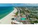 Aerial shot of beachfront condo complex with tennis courts, a community pool, and direct beach access at 4950 Gulf Blvd # 409, St Pete Beach, Fl, FL 33706
