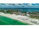 Aerial view of beachfront condo and turquoise waters, offering an array of convenient amenities at 4950 Gulf Blvd # 409, St Pete Beach, Fl, FL 33706