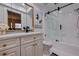 Well-lit bathroom with a glass shower and white cabinets featuring updated fixtures and bright countertop at 4950 Gulf Blvd # 409, St Pete Beach, Fl, FL 33706