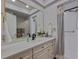 Bright bathroom featuring a large mirror, vanity with sink, a toilet, and a shower with curtain at 4950 Gulf Blvd # 409, St Pete Beach, Fl, FL 33706
