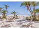 Community patio with dining and lounge seating, in addition to ocean views at 4950 Gulf Blvd # 409, St Pete Beach, Fl, FL 33706