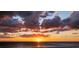 Beautiful sunset view of the ocean with vibrant orange and purple clouds at 4950 Gulf Blvd # 409, St Pete Beach, Fl, FL 33706