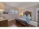 Comfortable bedroom featuring hardwood floors, a queen bed with a wooden frame, and bright natural light at 4950 Gulf Blvd # 409, St Pete Beach, Fl, FL 33706