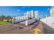 Exterior view showing a ramp leading up to the Beau Monde building with tennis court on top of parking structure at 4950 Gulf Blvd # 409, St Pete Beach, Fl, FL 33706