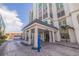 Exterior view showcasing the entrance, with large columns and covered area for drop-off at 4950 Gulf Blvd # 409, St Pete Beach, Fl, FL 33706