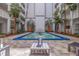 Beautiful courtyard area with decorative water fountain and decorative landscaping surrounded by the building at 4950 Gulf Blvd # 409, St Pete Beach, Fl, FL 33706