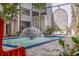 Outdoor courtyard with fountain, lush greenery and patio seating area at 4950 Gulf Blvd # 409, St Pete Beach, Fl, FL 33706