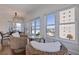 Bright dining area with wicker chairs, glass table, and large windows overlooking the beach and ocean views at 4950 Gulf Blvd # 409, St Pete Beach, Fl, FL 33706
