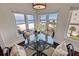 Inviting dining area with ocean views, seating for four, and bright natural light from surrounding windows at 4950 Gulf Blvd # 409, St Pete Beach, Fl, FL 33706