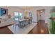 Inviting dining area with hardwood floors, bright chandelier, and an adjacent room with lots of light at 4950 Gulf Blvd # 409, St Pete Beach, Fl, FL 33706