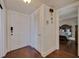 Entryway to bedroom showing the front door, a bedroom door, and hardwood floors at 4950 Gulf Blvd # 409, St Pete Beach, Fl, FL 33706