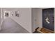 Condo hallway with a blue door, welcome mat, and view down the hallway to common space at 4950 Gulf Blvd # 409, St Pete Beach, Fl, FL 33706