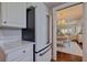 Eat in kitchen shows granite countertops, stainless refrigerator, with views to the dining and living area at 4950 Gulf Blvd # 409, St Pete Beach, Fl, FL 33706