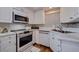 Efficient kitchen with modern appliances, bright white cabinets, and ample countertop space for meal preparation at 4950 Gulf Blvd # 409, St Pete Beach, Fl, FL 33706