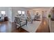 Open-concept living room with hardwood floors, bright windows, comfortable seating, and adjacent dining area at 4950 Gulf Blvd # 409, St Pete Beach, Fl, FL 33706