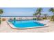 Inviting outdoor pool steps from the beach with lounge chairs in the background at 4950 Gulf Blvd # 409, St Pete Beach, Fl, FL 33706