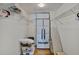 Walk in closet shows a stacked washer and dryer and wire shelving for storage at 4950 Gulf Blvd # 409, St Pete Beach, Fl, FL 33706