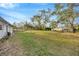 Lush backyard space with a wooden fence and a tree at 5526 Southernview Dr, Zephyrhills, FL 33541