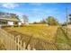 A large yard is bordered by a wooden fence and lush green grass at 5526 Southernview Dr, Zephyrhills, FL 33541