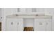 Close up of bathroom featuring dual sinks, quartz counters, and white cabinets at 5526 Southernview Dr, Zephyrhills, FL 33541