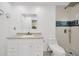 A modern bathroom features a vanity, stone counter, and updated shower at 5526 Southernview Dr, Zephyrhills, FL 33541