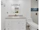 Modern bathroom with tiled floors, quartz counters and framed mirror at 5526 Southernview Dr, Zephyrhills, FL 33541