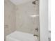 Close up of bathroom featuring white marble tiling and bronze fixtures at 5526 Southernview Dr, Zephyrhills, FL 33541