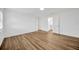 Bright bedroom featuring wood-look floors, white walls, and an ensuite bathroom at 5526 Southernview Dr, Zephyrhills, FL 33541
