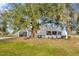 Home exterior with lush greenery and a unique architectural design at 5526 Southernview Dr, Zephyrhills, FL 33541