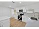 Modern kitchen with white cabinets, stainless appliances, and stylish backsplash at 5526 Southernview Dr, Zephyrhills, FL 33541